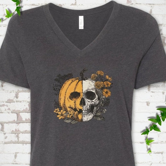 Dark Grey Heather Bella Canvas® ladies' V-neck T-shirt flat lay featuring a half-pumpkin, half-skull botanical Halloween graphic.