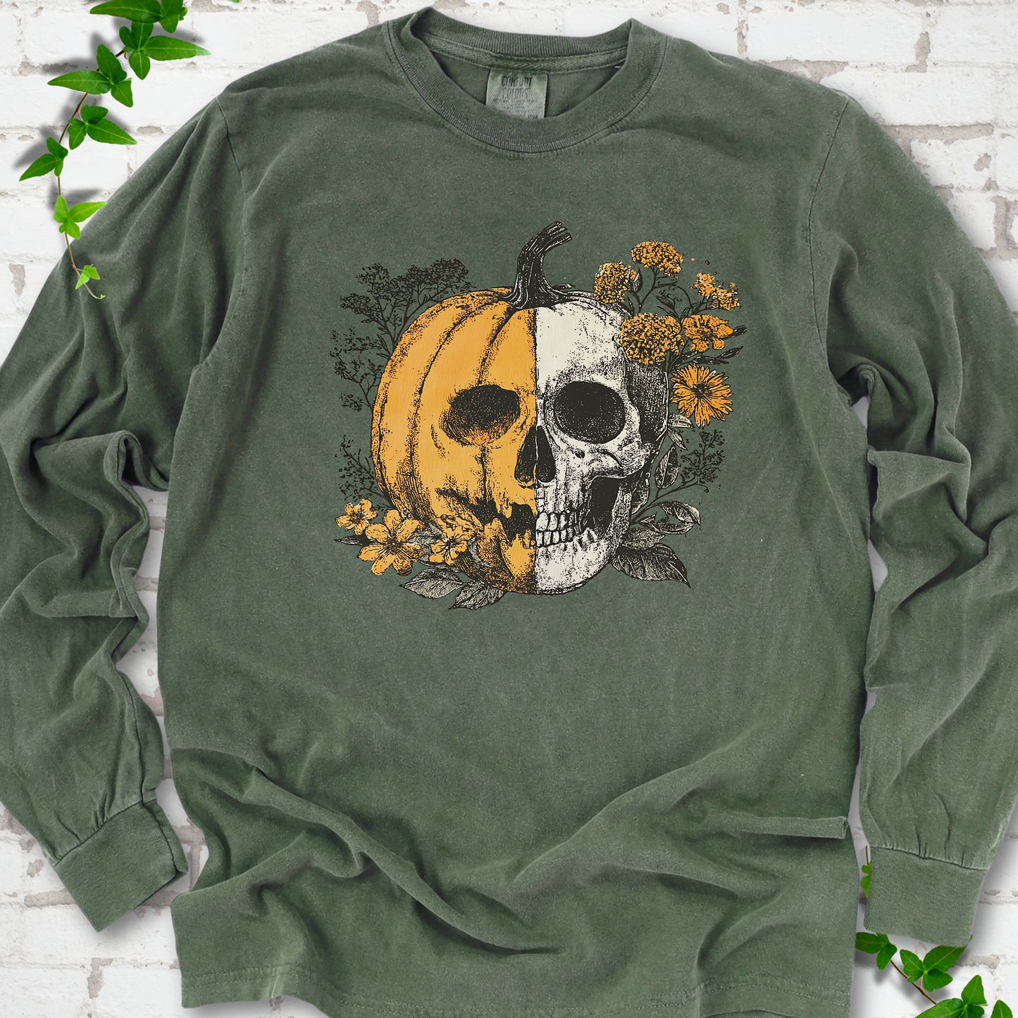 Hemp Comfort Colors® long sleeve T-shirt flat lay featuring a half-pumpkin, half-skull botanical Halloween graphic.