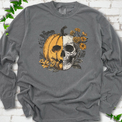 Pepper Comfort Colors® long sleeve T-shirt flat lay featuring a half-pumpkin, half-skull botanical Halloween graphic.