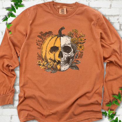 Yam Comfort Colors® long sleeve T-shirt flat lay featuring a half-pumpkin, half-skull botanical Halloween graphic.