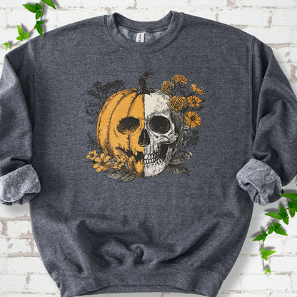 Dark Heather Gildan® 18000 crewneck sweatshirt flat lay featuring a half-pumpkin, half-skull design with autumn flowers.