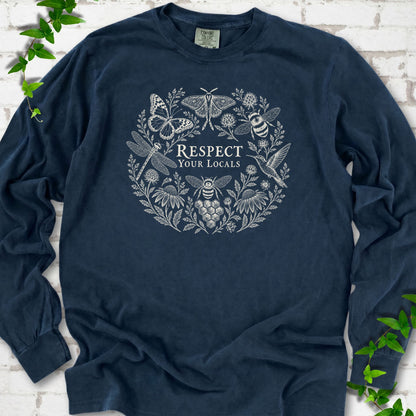 Midnight Comfort Colors® long sleeve tee flat lay featuring the words “Respect Your Locals” surrounded by pollinating insects, a hummingbird and flowers.