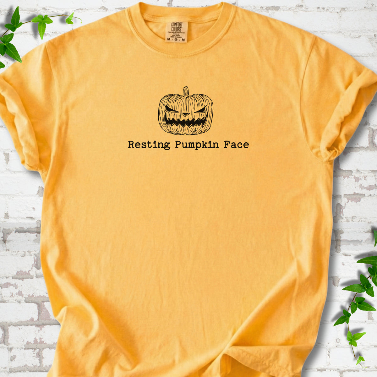 Resting Pumpkin Face funny Halloween T-shirt in Citrus with jack-o'-lantern face graphic