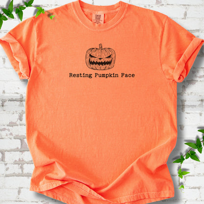 Resting Pumpkin Face funny Halloween T-shirt in Melon with jack-o'-lantern face graphic