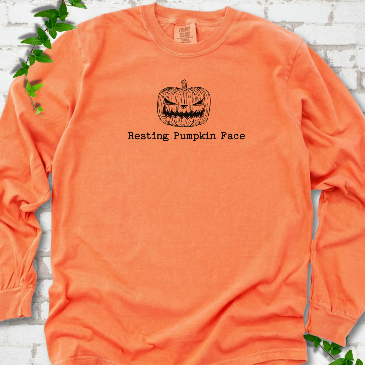 Resting Pumpkin Face funny Halloween long sleeve shirt in Melon with jack-o'-lantern face graphic