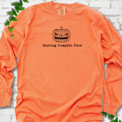 Resting Pumpkin Face funny Halloween long sleeve shirt in Melon with jack-o'-lantern face graphic
