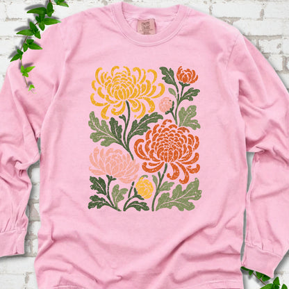 Blossom Comfort Colors® long sleeve T-shirt flat lay with a distressed multicolor chrysanthemum garden graphic on a white brick background with ivy accents
