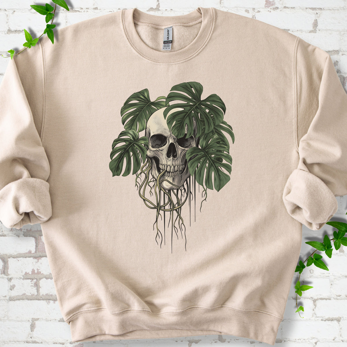 Sand classic sweatshirt shown flat with the Root Bound Monstera skull and trailing roots graphic