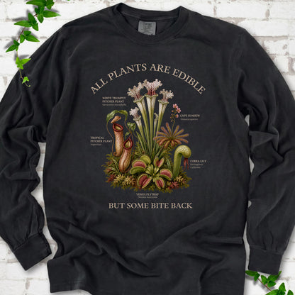 Black Comfort Colors® long sleeve T-shirt front mockup featuring a botanical illustration of various carnivorous plants including a Venus Flytrap, Pitcher Plants, Cape Sundew, and Cobra Lily.