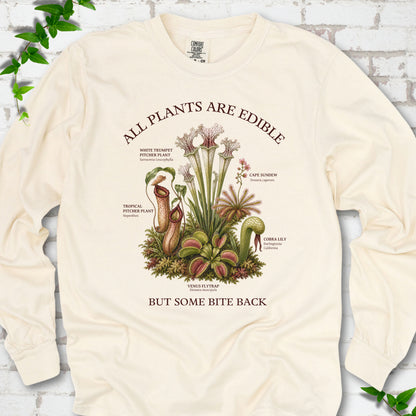 Ivory Comfort Colors® long sleeve T-shirt front mockup featuring a botanical illustration of various carnivorous plants including a Venus Flytrap, Pitcher Plants, Cape Sundew, and Cobra Lily.