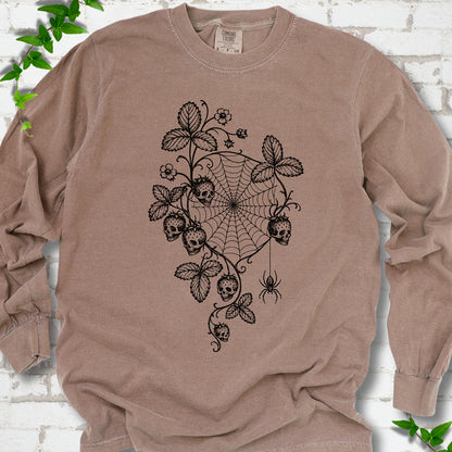 Espresso Comfort Colors® long sleeve T-shirt flat lay featuring skull-shaped strawberries, curling leaves, a spiderweb and a hanging spider.