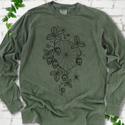 Hemp Comfort Colors® long sleeve T-shirt flat lay featuring skull-shaped strawberries, curling leaves, a spiderweb and a hanging spider.