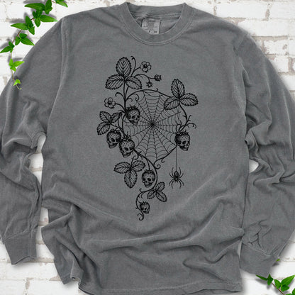 Pepper Comfort Colors® long sleeve T-shirt flat lay featuring skull-shaped strawberries, curling leaves, a spiderweb and a hanging spider.