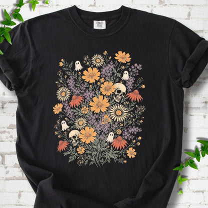 Black Comfort Colors® T-shirt flat lay featuring a colorful wildflower bouquet with tiny ghosts and skulls.