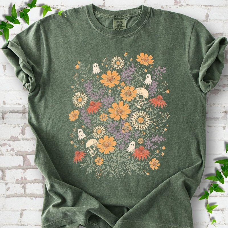 Moss Comfort Colors® T-shirt flat lay featuring a colorful wildflower bouquet with tiny ghosts and skulls.