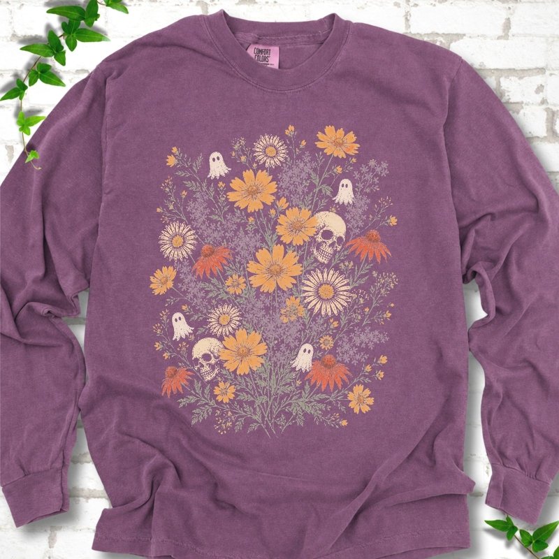 Berry Comfort Colors® long sleeve T-shirt flat lay featuring a colorful wildflower bouquet with tiny ghosts and skulls.