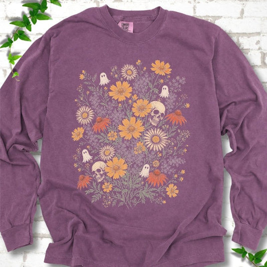 Berry Comfort Colors® long sleeve T-shirt flat lay featuring a colorful wildflower bouquet with tiny ghosts and skulls.