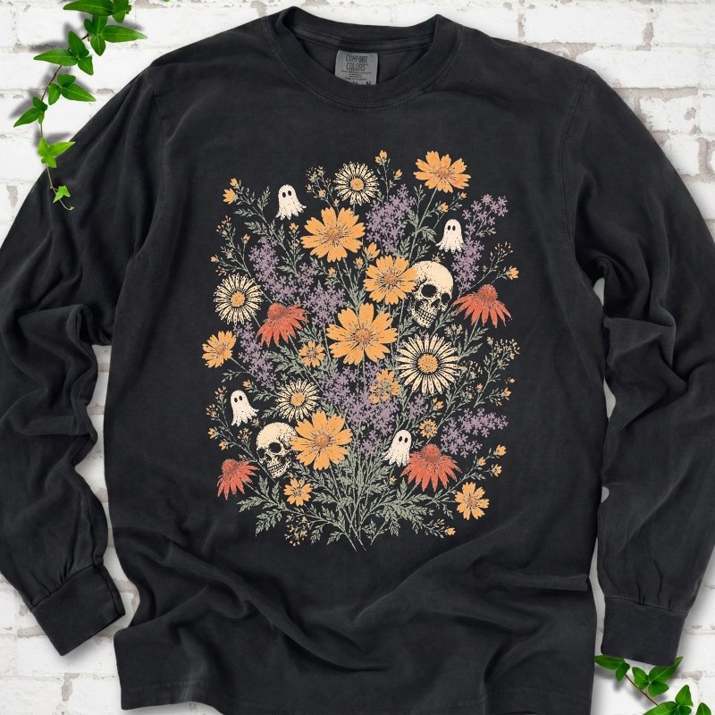 Black Comfort Colors® long sleeve T-shirt flat lay featuring a colorful wildflower bouquet with tiny ghosts and skulls.