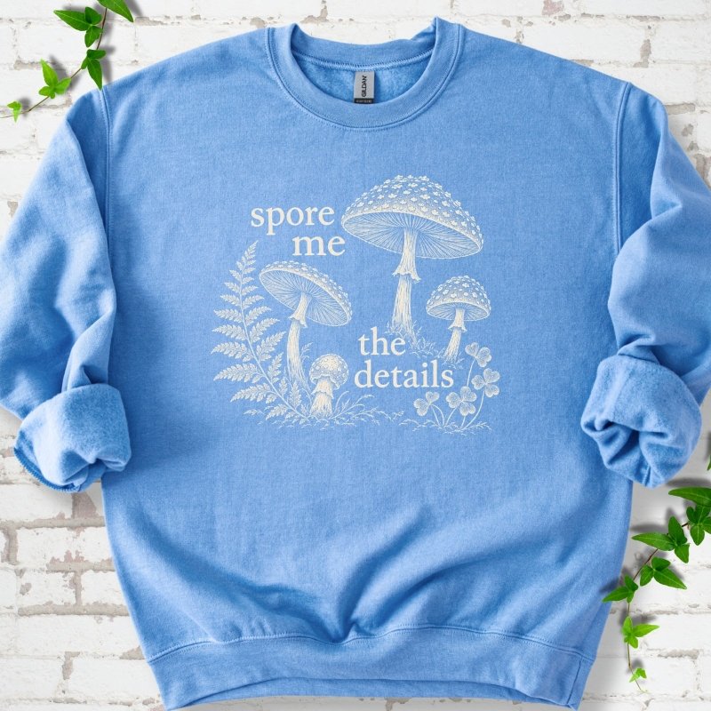 Carolina Blue crewneck sweatshirt with "spore me the details" and engraved toadstools, fern and clover in cream ink