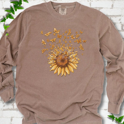 Espresso Comfort Colors® long sleeve T-shirt flat lay featuring a sunflower releasing a burst of orange butterflies.
