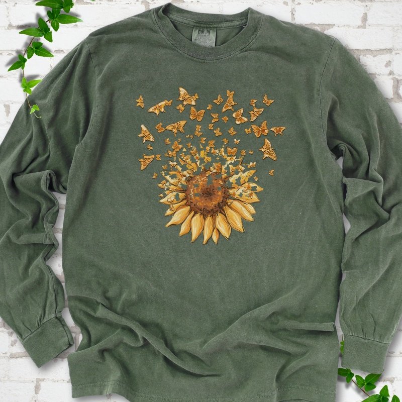Hemp Comfort Colors® long sleeve T-shirt flat lay featuring a sunflower releasing a burst of orange butterflies.
