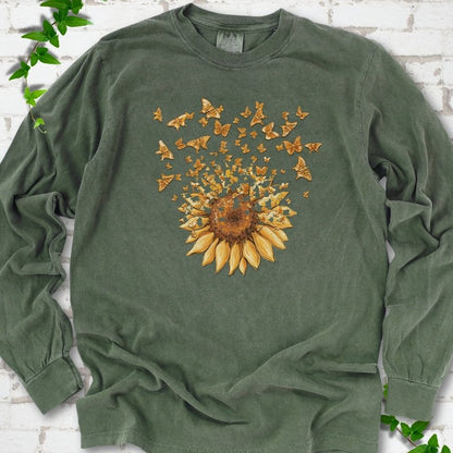 Hemp Comfort Colors® long sleeve T-shirt flat lay featuring a sunflower releasing a burst of orange butterflies.