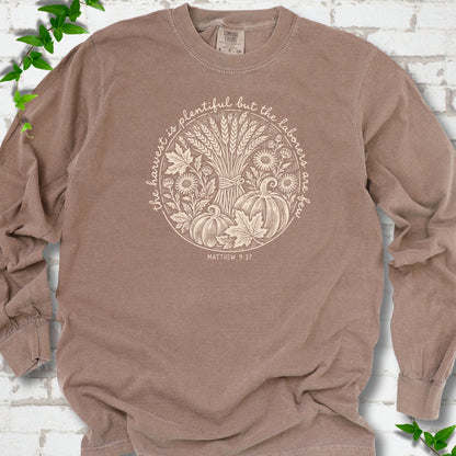 Espresso long sleeve T-shirt flat lay with cream wheat, pumpkins and leaves in a harvest circle, the Matthew 9:37 verse around it and its reference below.