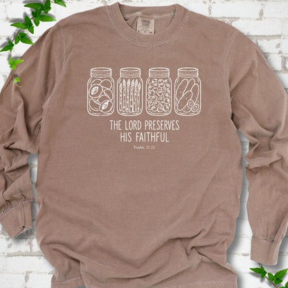 Espresso long sleeve T-shirt flat lay with white line-art illustrations of four mason jars filled with peaches, asparagus, blueberries and pickles above the words "The Lord Preserves His Faithful" and small "Psalm 31:23", on white brick with ivy sprigs.