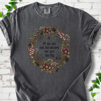 Pepper T-shirt flat-lay mockup with a gothic floral wreath, spider webs and "If we are not the weaver, we are the fly" lettering.