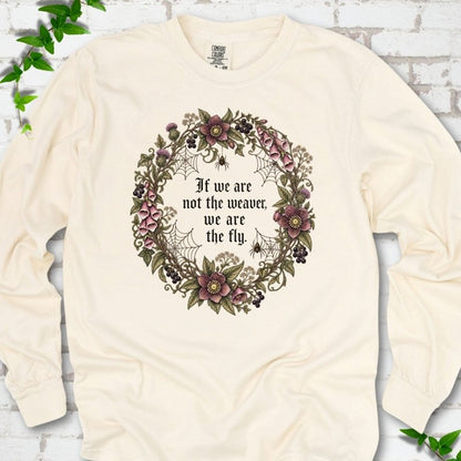 Ivory long sleeve T-shirt flat-lay mockup with a gothic floral wreath, spider webs and "If we are not the weaver, we are the fly" lettering.