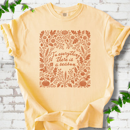 Butter Comfort Colors® T-shirt flat lay with botanical To Everything There Is a Season Bible verse artwork.