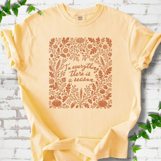 Butter Comfort Colors® T-shirt flat lay with botanical To Everything There Is a Season Bible verse artwork.
