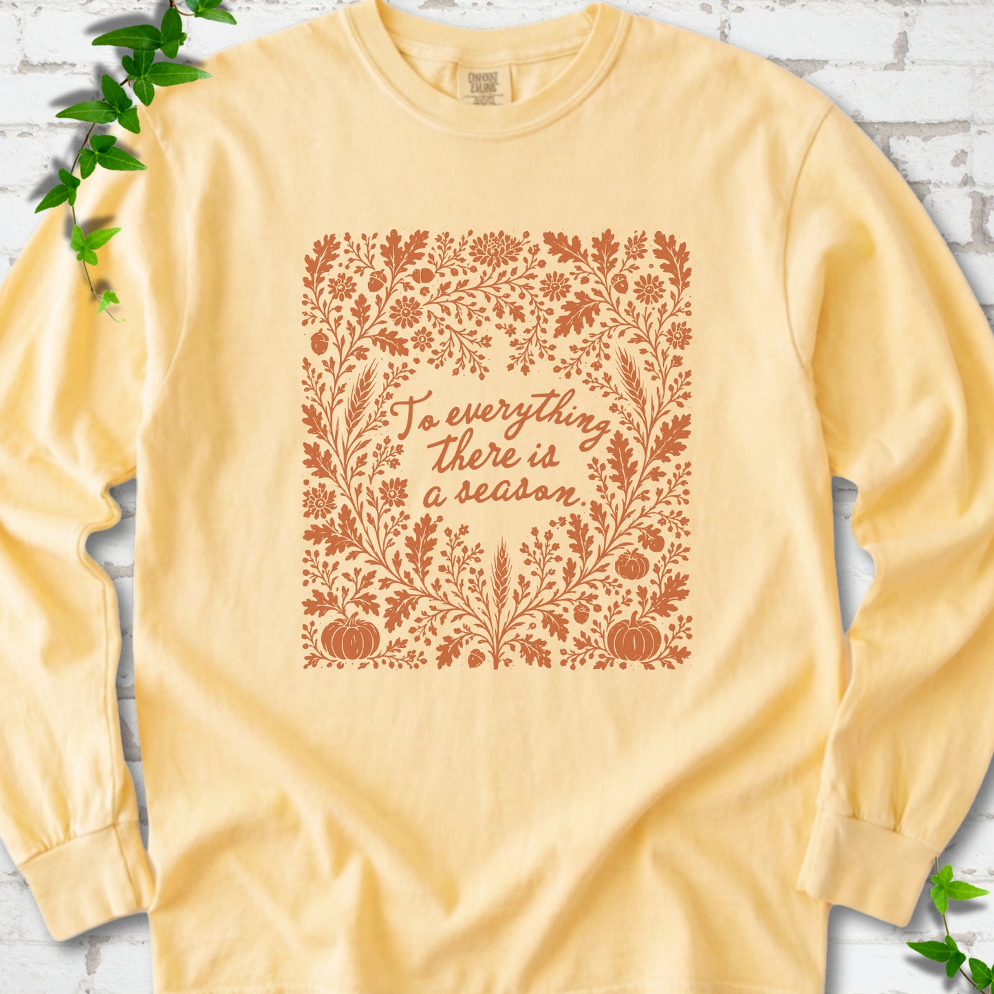 Butter Comfort Colors® long sleeve T-shirt flat lay with botanical To Everything There Is a Season Bible verse artwork.