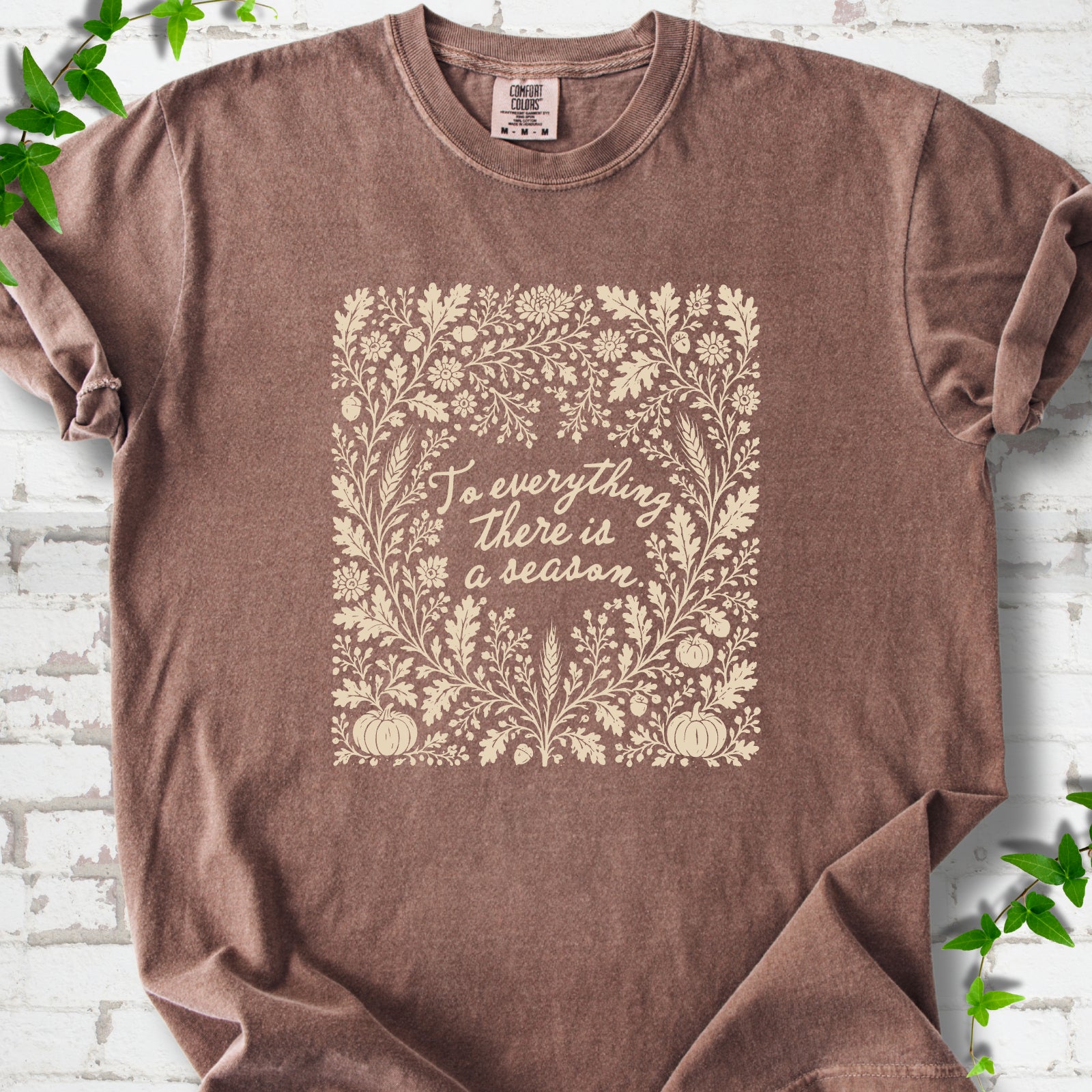 Espresso Comfort Colors® T-shirt flat lay with botanical To Everything There Is a Season Bible verse artwork.