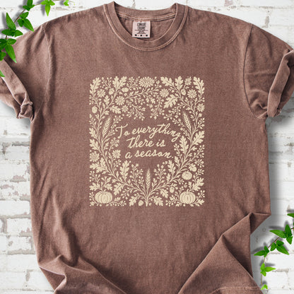 Espresso Comfort Colors® T-shirt flat lay with botanical To Everything There Is a Season Bible verse artwork.