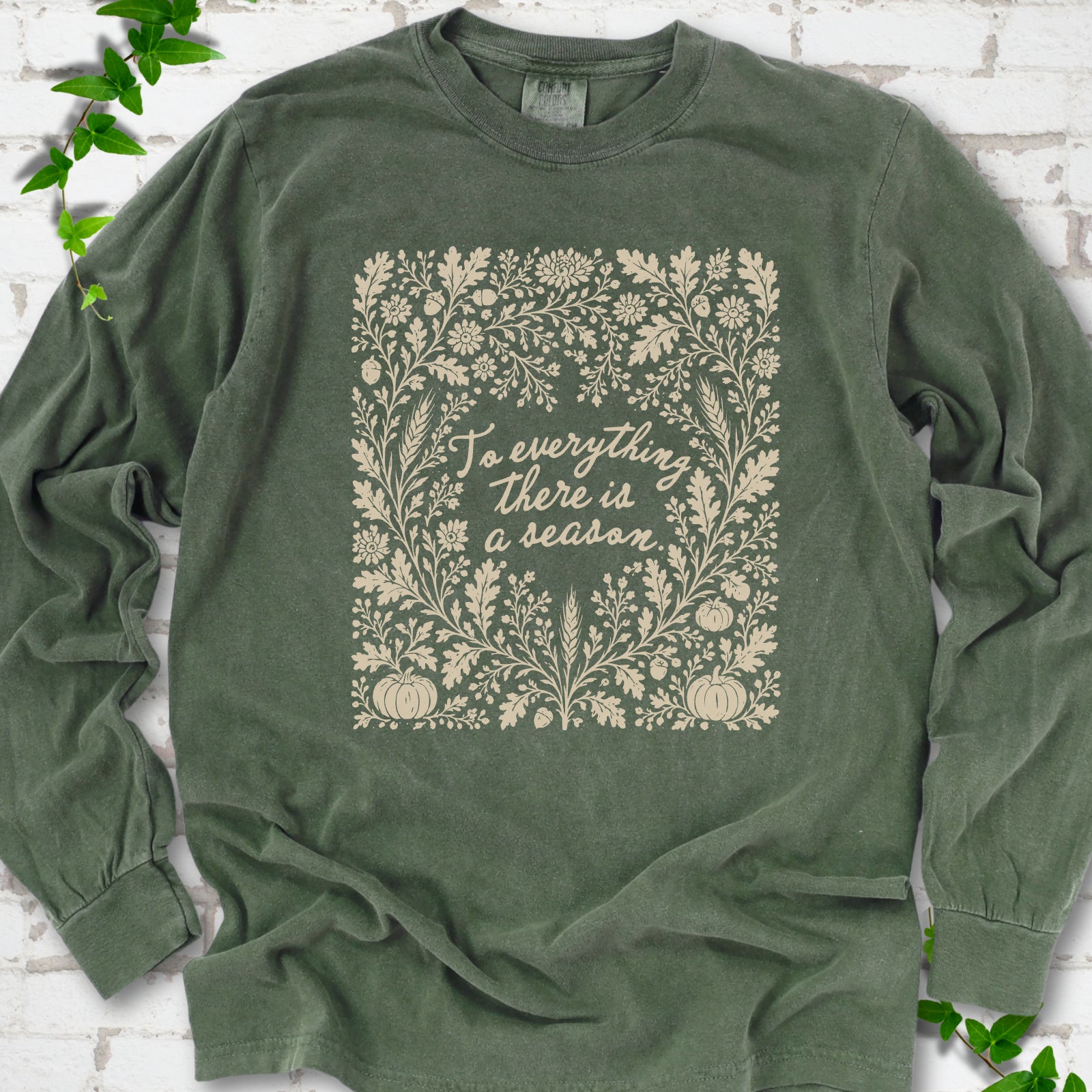 Hemp Comfort Colors® long sleeve T-shirt flat lay with botanical To Everything There Is a Season Bible verse artwork.