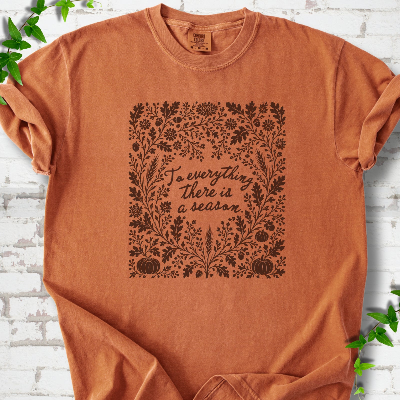 Yam Comfort Colors® T-shirt flat lay with botanical To Everything There Is a Season Bible verse artwork.