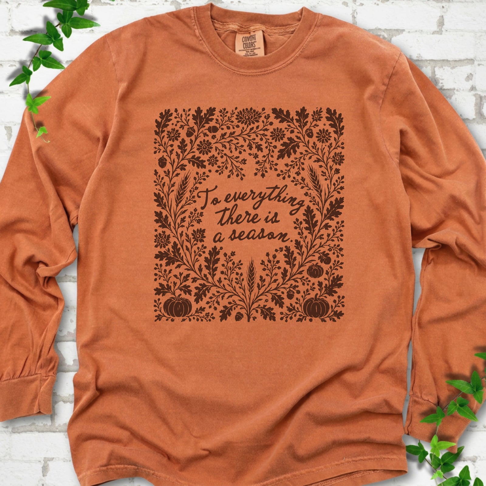 Yam Comfort Colors® long sleeve T-shirt flat lay with botanical To Everything There Is a Season Bible verse artwork.