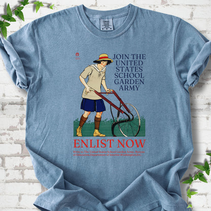 Blue Jean Comfort Colors® T-shirt featuring Edward Penfield’s 1918 School Garden Army poster with a young gardener, wheel hoe and “Enlist Now” text.