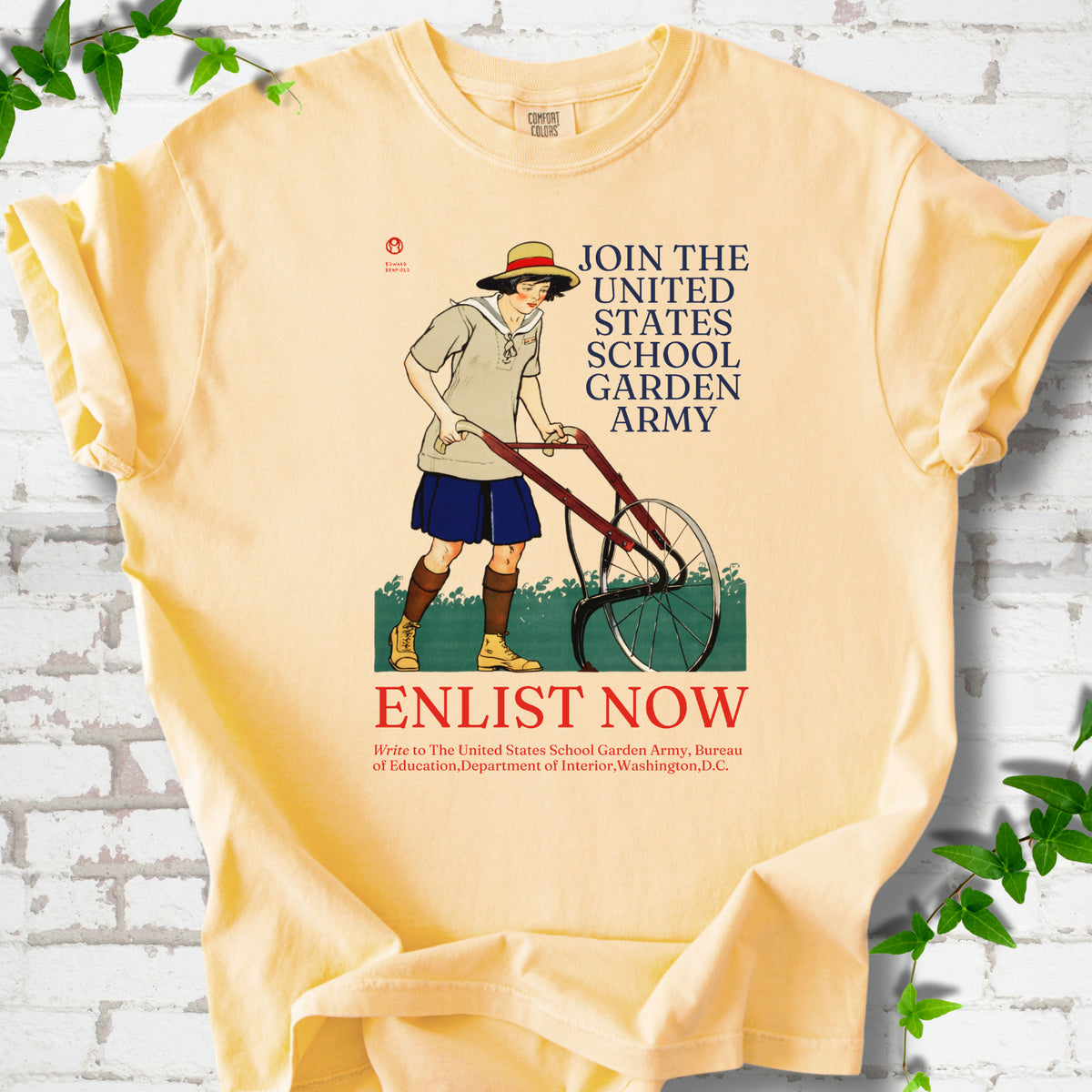 Butter Comfort Colors® T-shirt featuring Edward Penfield’s 1918 School Garden Army poster with a young gardener, wheel hoe and “Enlist Now” text.