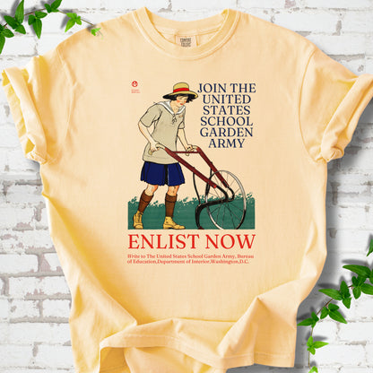 Butter Comfort Colors® T-shirt featuring Edward Penfield’s 1918 School Garden Army poster with a young gardener, wheel hoe and “Enlist Now” text.