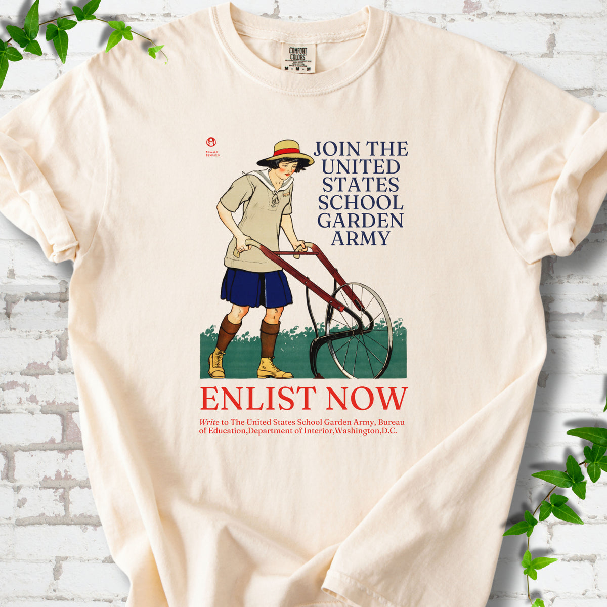Ivory Comfort Colors® T-shirt featuring Edward Penfield’s 1918 School Garden Army poster with a young gardener, wheel hoe and “Enlist Now” text.