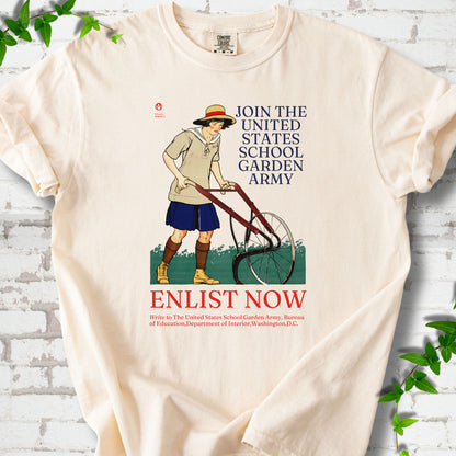 Ivory Comfort Colors® T-shirt featuring Edward Penfield’s 1918 School Garden Army poster with a young gardener, wheel hoe and “Enlist Now” text.
