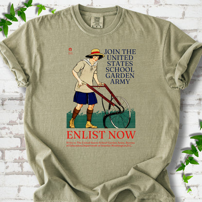 Khaki Comfort Colors® T-shirt featuring Edward Penfield’s 1918 School Garden Army poster with a young gardener, wheel hoe and “Enlist Now” text.