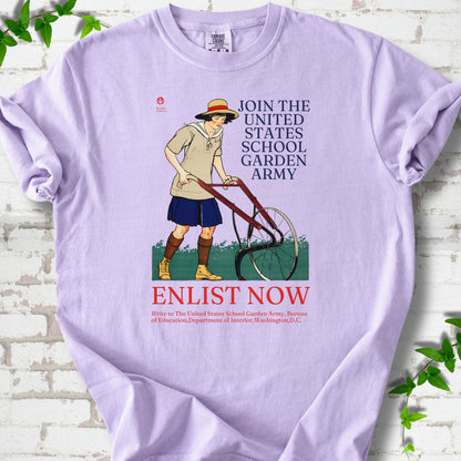 Orchid Comfort Colors® T-shirt featuring Edward Penfield’s 1918 School Garden Army poster with a young gardener, wheel hoe and “Enlist Now” text.