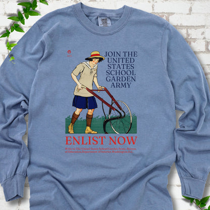 Blue Jean Comfort Colors® long sleeve shirt featuring Edward Penfield’s 1918 School Garden Army poster with a young gardener, wheel hoe and “Enlist Now” text.