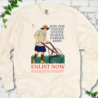 Ivory Comfort Colors® long sleeve shirt featuring Edward Penfield’s 1918 School Garden Army poster with a young gardener, wheel hoe and “Enlist Now” text.