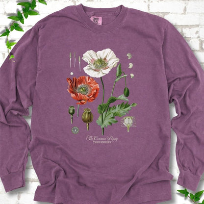 Berry Comfort Colors® long sleeve T-shirt flat lay featuring vintage botanical poppy studies from bud to seed head.