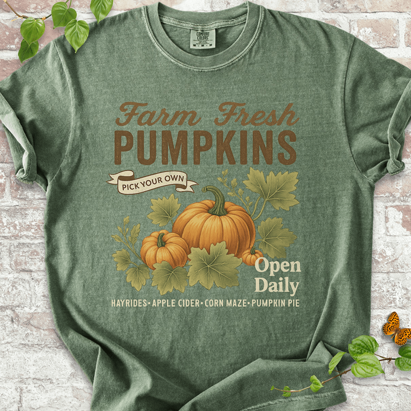 Vintage Pumpkin T-shirt on Comfort Colors™ Moss – includes two illustrated pumpkins and curling leaves with fall fair vibes and cozy farmhouse text like "Corn Maze" and "Pumpkin Pie"
