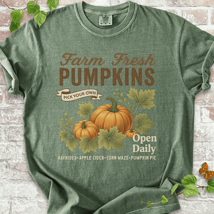 Vintage Pumpkin T-shirt on Comfort Colors™ Moss – includes two illustrated pumpkins and curling leaves with fall fair vibes and cozy farmhouse text like "Corn Maze" and "Pumpkin Pie"